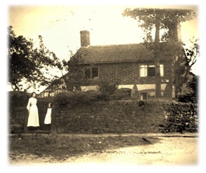 Edwardian mother and child outside old house